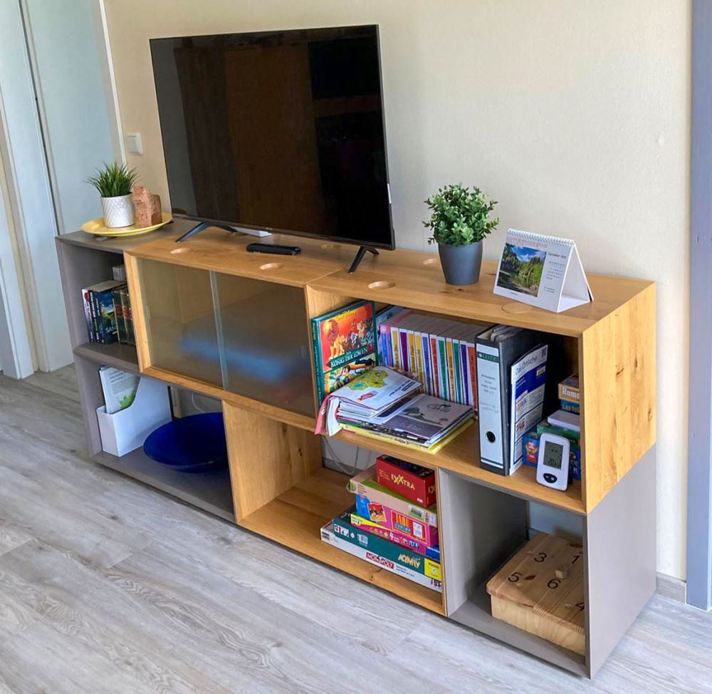 Sideboard mit Fernseher, Büchern und Spielen
